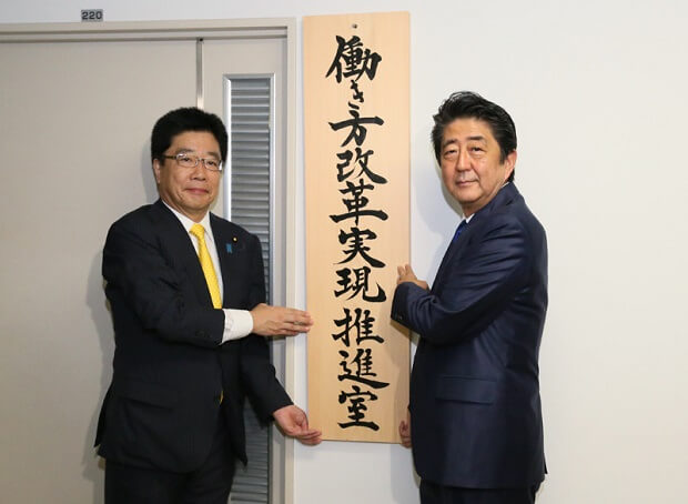 「働き方改革実現推進室」の開所式で看板を掛ける安倍首相（右）と加藤勝信働き方改革担当相。